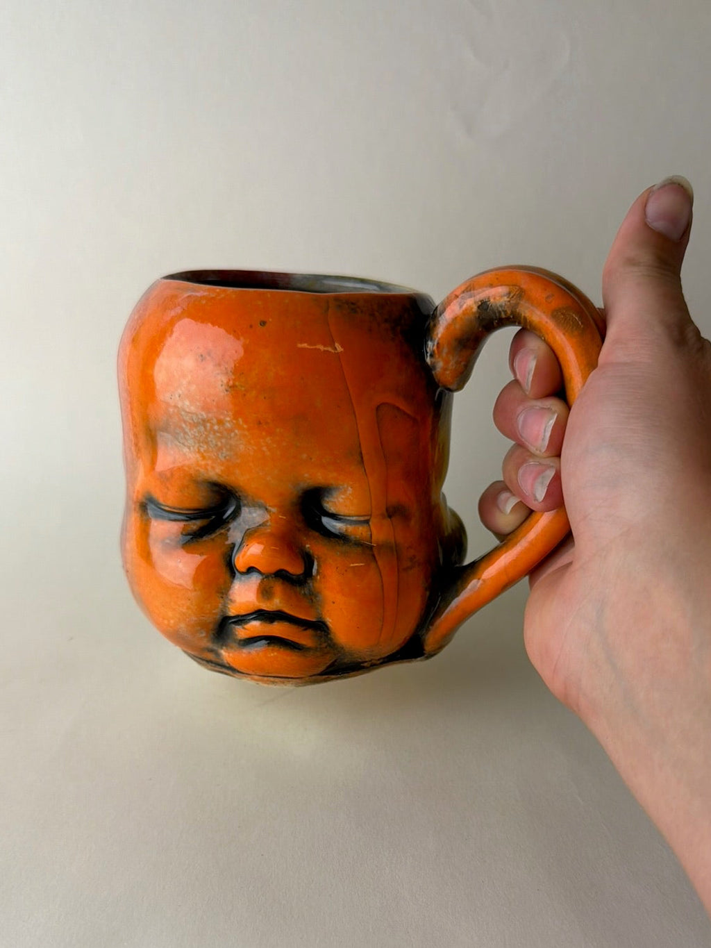 Three Face Baby Doll Head Mug, Warm Colors