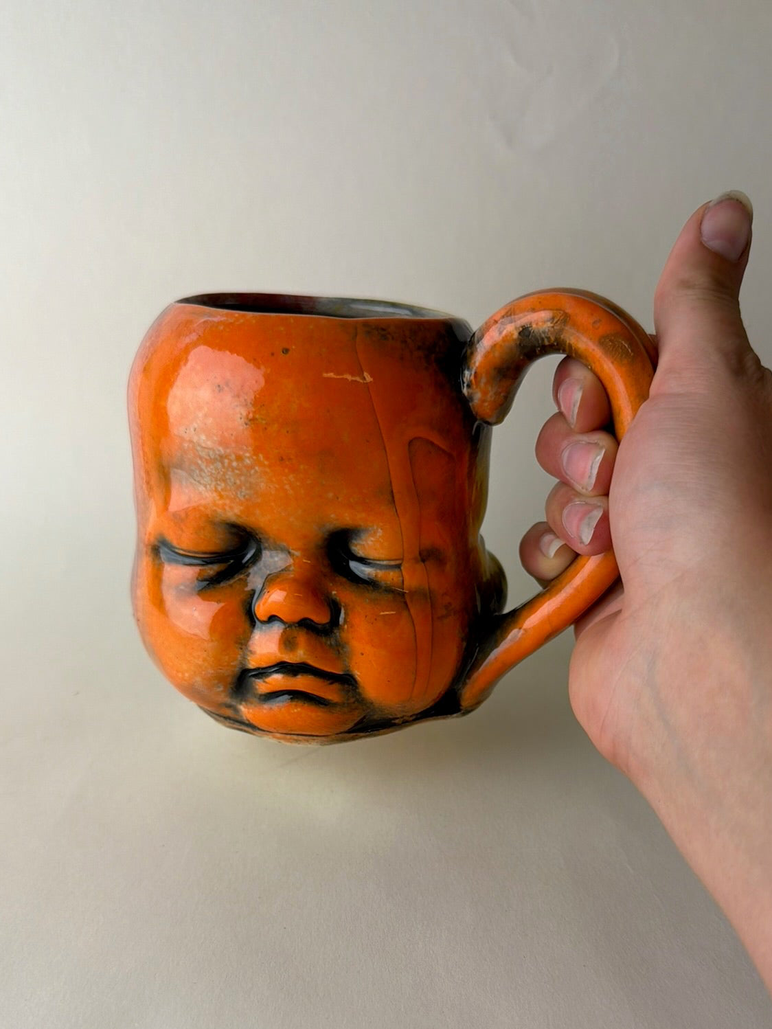 Three Face Baby Doll Head Mug, Warm Colors