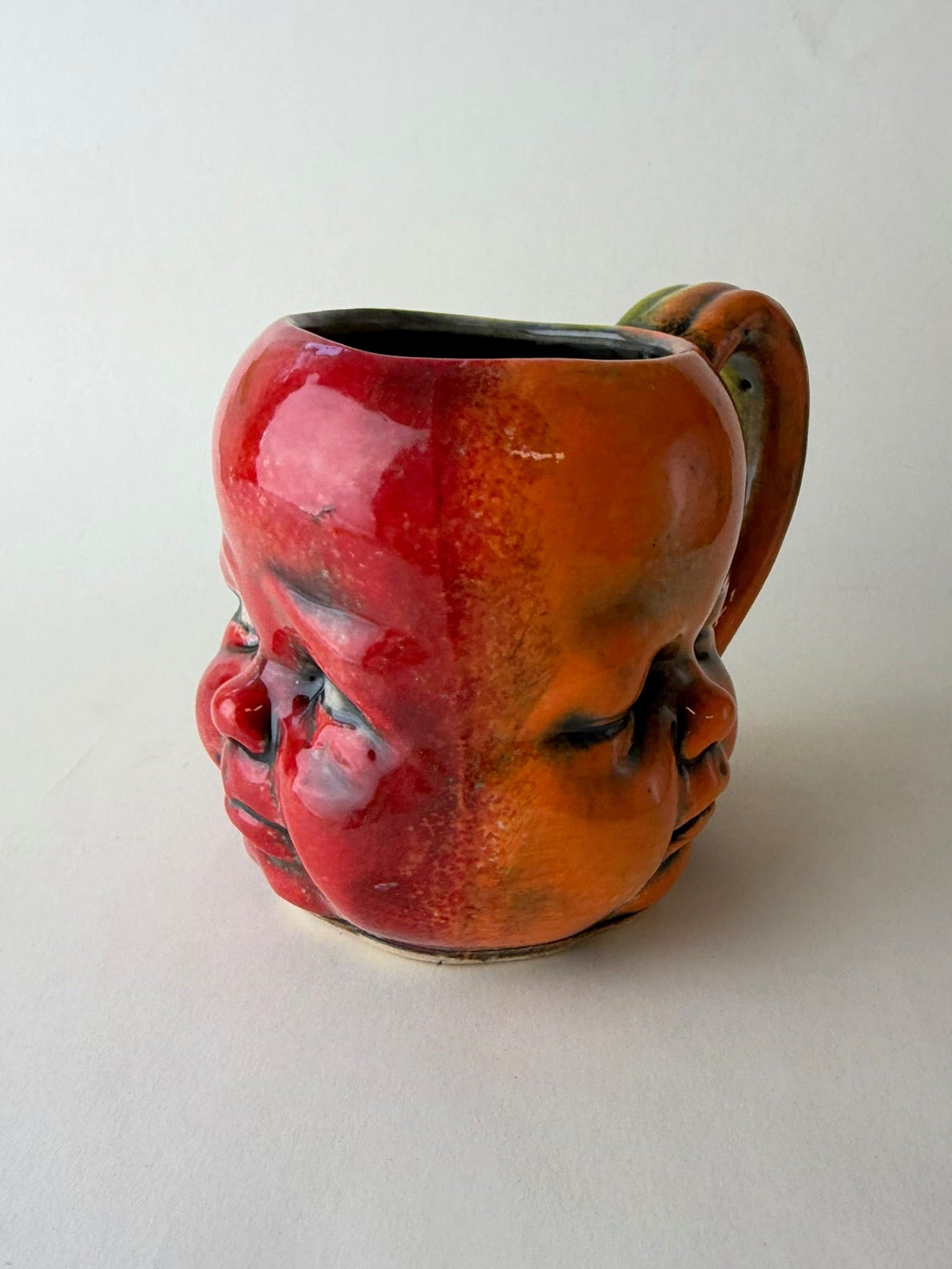 Three Face Baby Doll Head Mug, Warm Colors