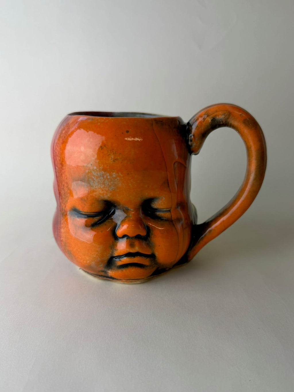 Three Face Baby Doll Head Mug, Warm Colors