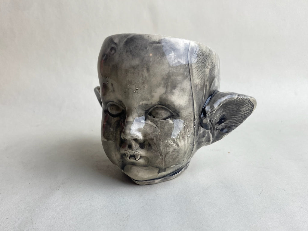 Monster Baby Doll Head With Pointed Ears and Fangs